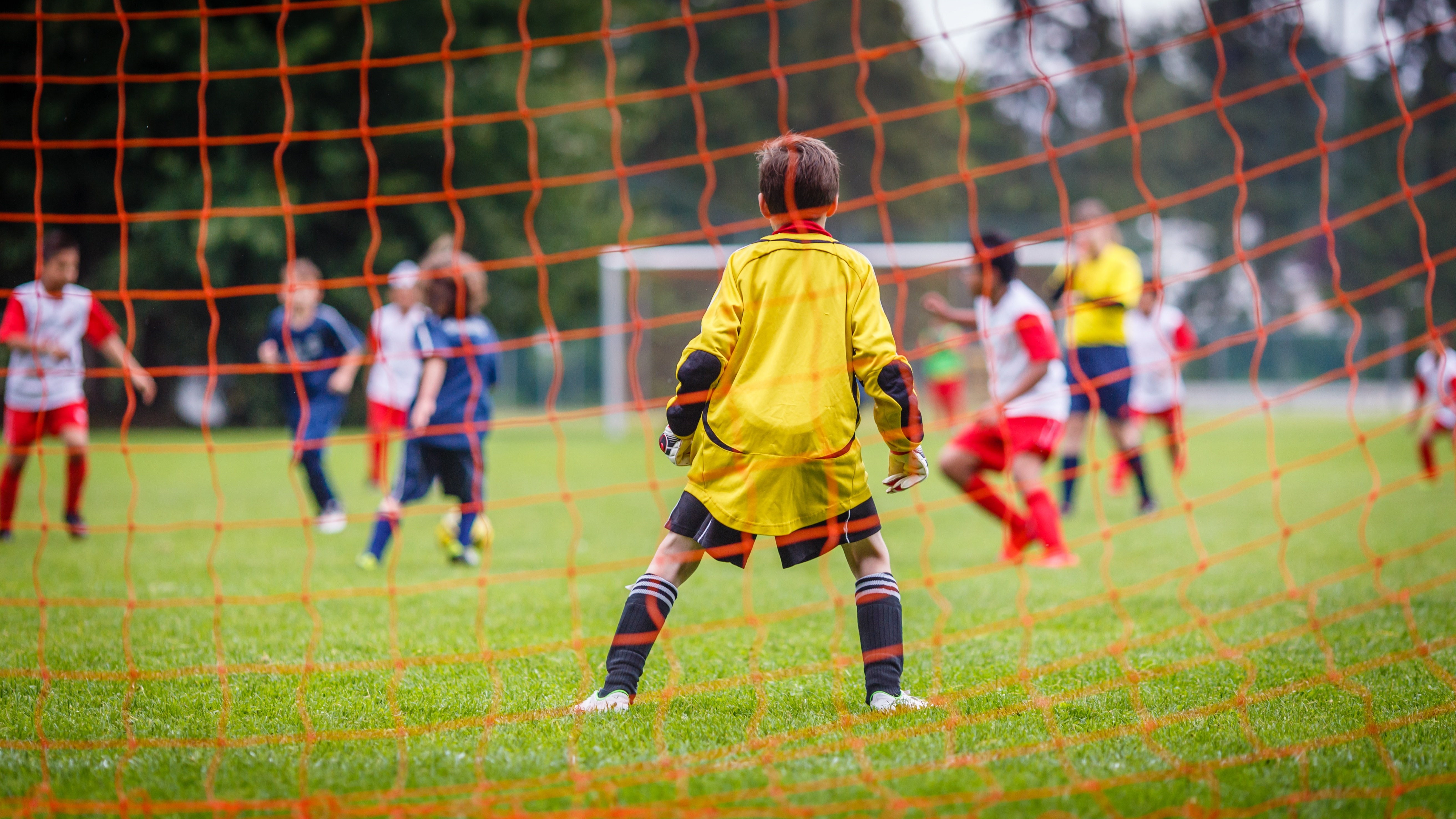 Photograph of young soccer goalie defending the net