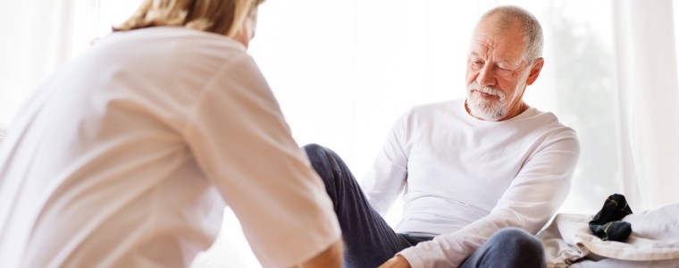 Photograph of diabetic elderly man receiving routine foot care