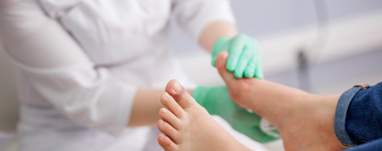 Photograph of podiatrist examining feet with injured great toe