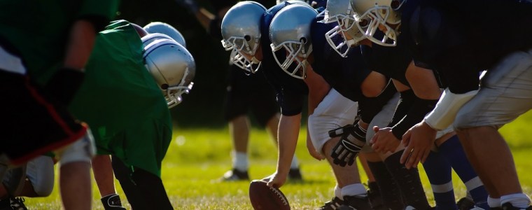 Photograph of two youth football team at the scrimmage line
