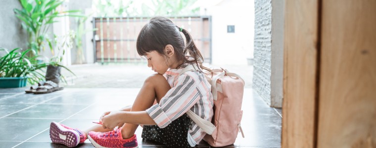 Little girl putting her shoes on by herself